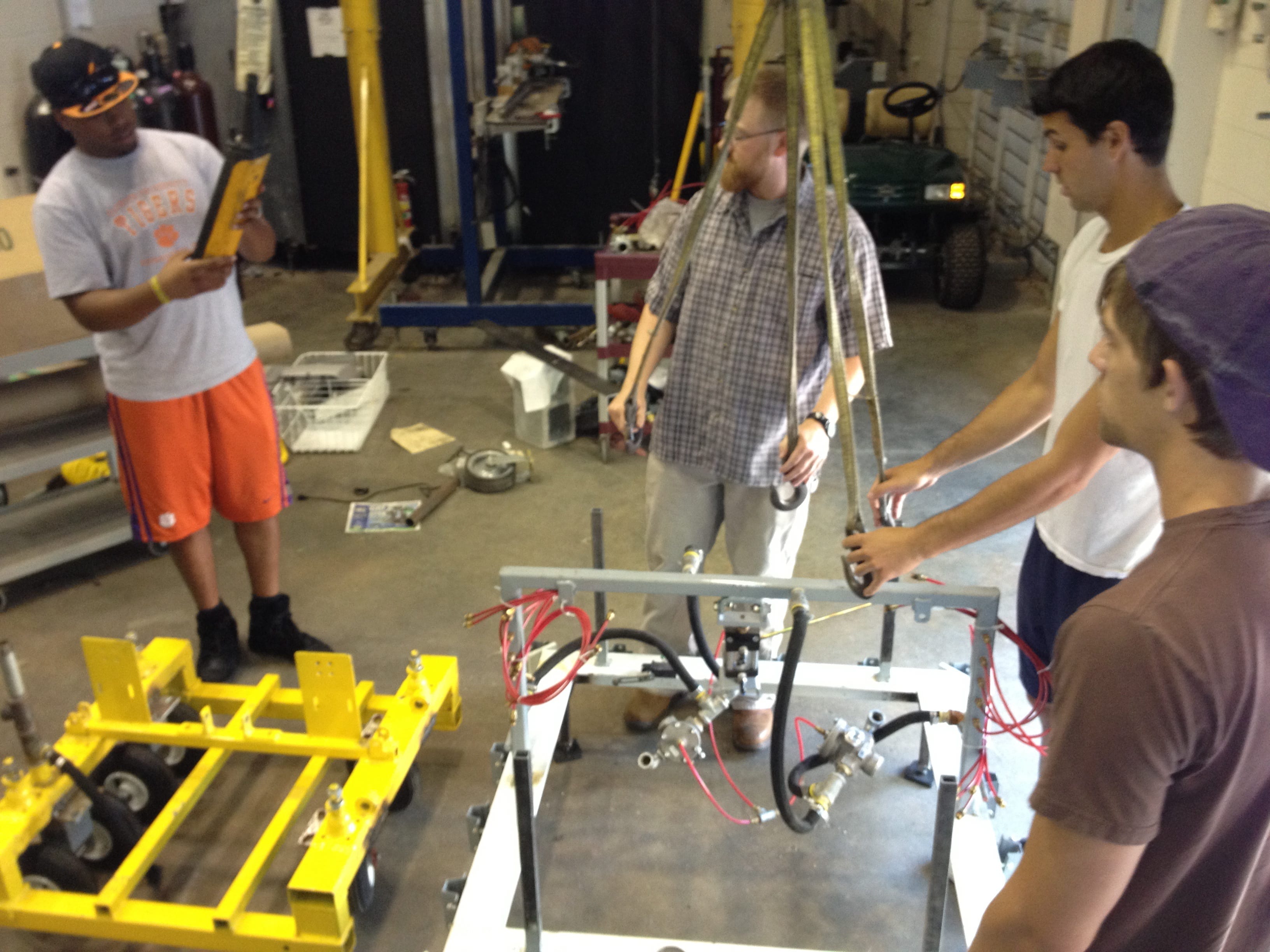 Clemson student researchers reassemble the mobile drill press. Photo by Gregory Mocko