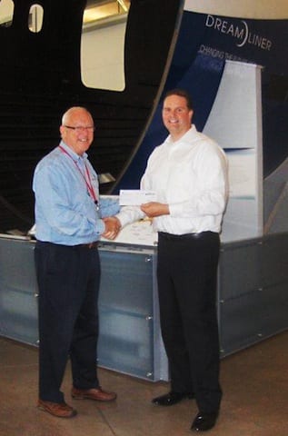 The PPG Industries Foundation donated $5,000 to the Future of Flight Foundation (FoFF) to support a program that exposes local students to various STEM (science, technology, engineering and math) careers and challenges them to master scientific concepts. Here, Jeff Masiwchuk (at right), business manager for the Seattle Application Support Center (ASC) of PPG Industries’ aerospace business, presents a check from the PPG Industries Foundation to Barry Smith, executive director of the Future of Flight Foundation.
