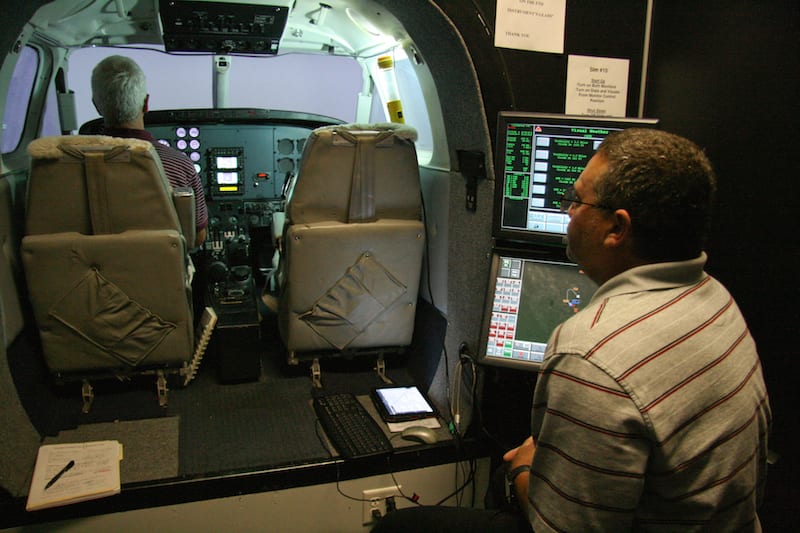  RTC instructor Mike Siegel conducting a Beech King Air simulator training session.