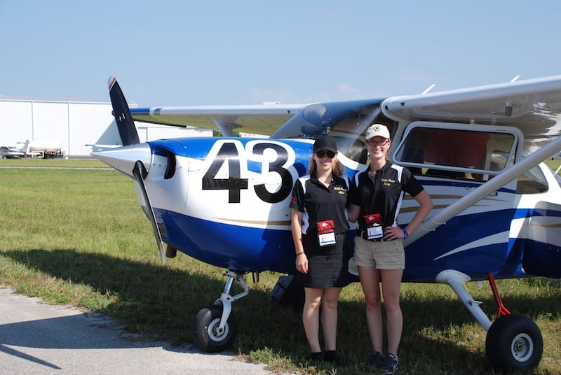 First place winners, Emmy Dillon and Amy Pasmore from Embry-Riddle Aeronautical University cool off with race plane, a Cessna Skyhawk. 