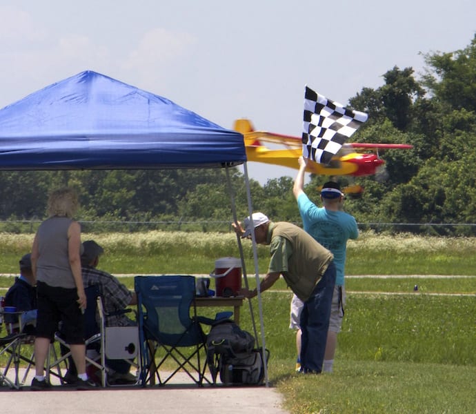 Timers drop the checkered flag on the last plane back, Race 132, a Kitfox 4 piloted by Mark Bybee, ending the 2016 Big Muddy Air Race. Although the slowest plane at 91.38 miles per hour, Bybee took first place in his Class by the virtue of being the only Experimental Light Sport in the race. By comparison, Canadian Wayne Hadath, Race 14, flew his F1 Rocket to the fastest speed in the race at 224.32 miles per hour. (Photo by Lisa F. Bentson)