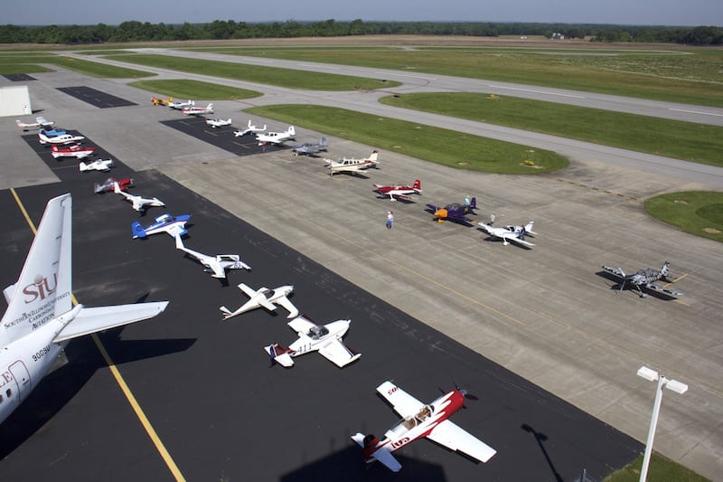 A bird’s eye view from the Southern Illinois Tower of the race planes lined up and ready to race. Race 53 is the second to the last plane on the right-hand row. The planes are arranged on the ramp in launch sequence, allowing for an orderly rollout that was elegant-looking for the spectators. (Photo by Lisa F. Bentson)