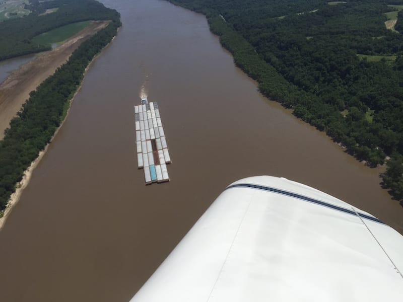 A tug pushes a barge upriver the day before the race in this image shot on Race 53’s practice run. The race’s short course crossed the river five times. (Photo by Lisa F. Bentson)