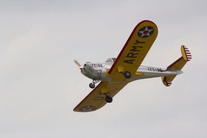 Mike Hardin wows the crowd with his flyby at the finish line, adjacent to the terminal where the spectators were gathered. The race planes flew down the grass strip between the taxiway and runway at 200 feet AGL for safety with good viewing. (Photo by Lisa F. Bentson)