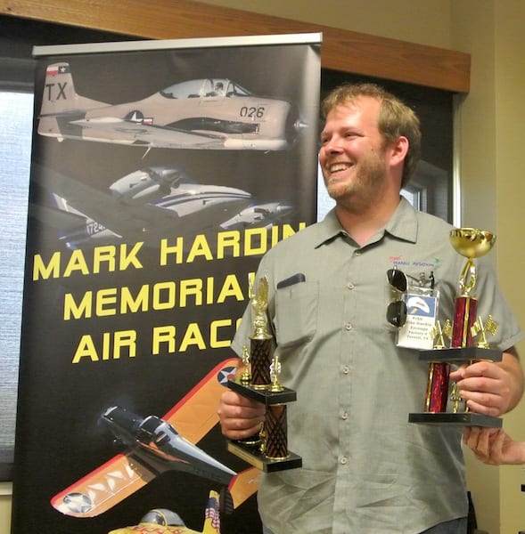 Mike Hardin accepting trophies for his second place finish and for his plane being chosen as the people’s favorite. Both race pilots and locals who attended the race were encouraged to vote for their favorite plane. The Hardin Ercoupe won the vote by a landslide. (Photo by Rio A. F. Dubois)