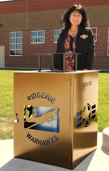 Principal Julie Yamamoto shows one of the campus fixtures that promotes the Warhawks ethos at the new Ridgevue High School in Nampa, Idaho. (Photo by Frederick A. Johnsen)