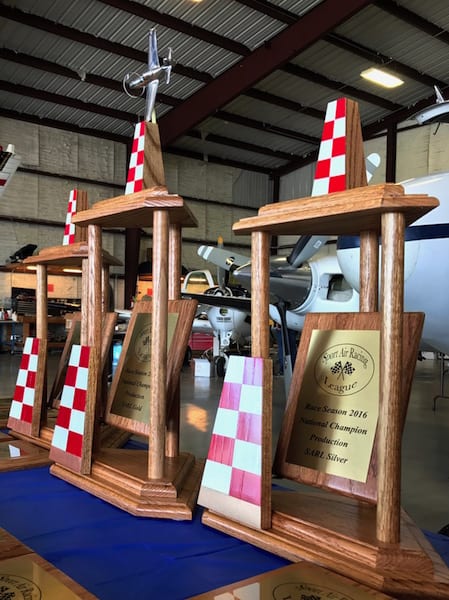Foreground: The season champ trophy Air Racer William E. Dubois won after the Rocket 100. Center: The trophy he had his sights set on all season long. It went to his rivals, Team Ely, who took home season Gold for the fifth time in a row. (Photo by Lisa F. Bentson)