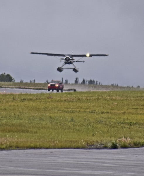 A DeHavilland Beaver on floats lifts off in a trailer-towed launch at Whitehorse Airport.